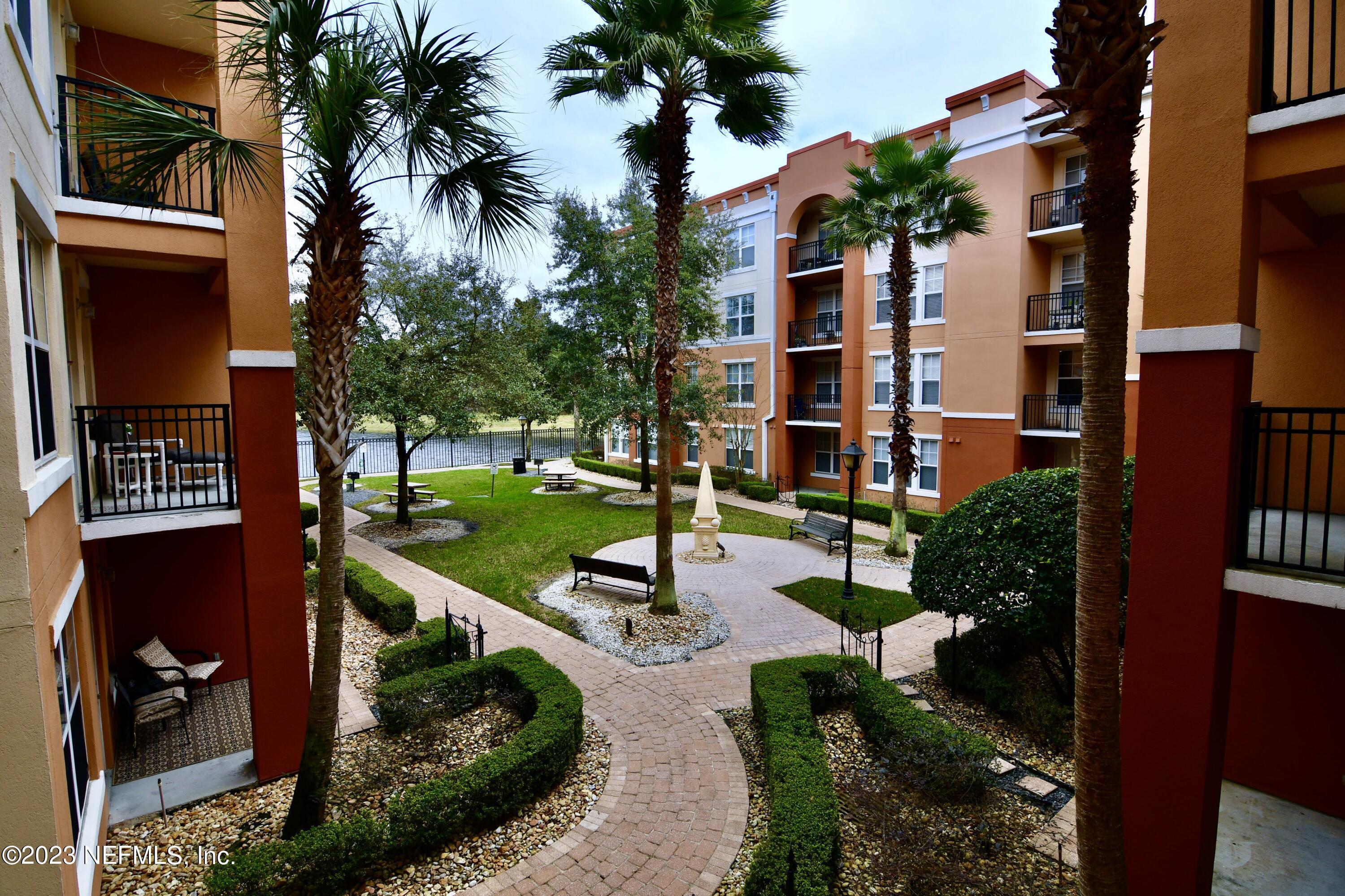 a view of a building with garden and patio