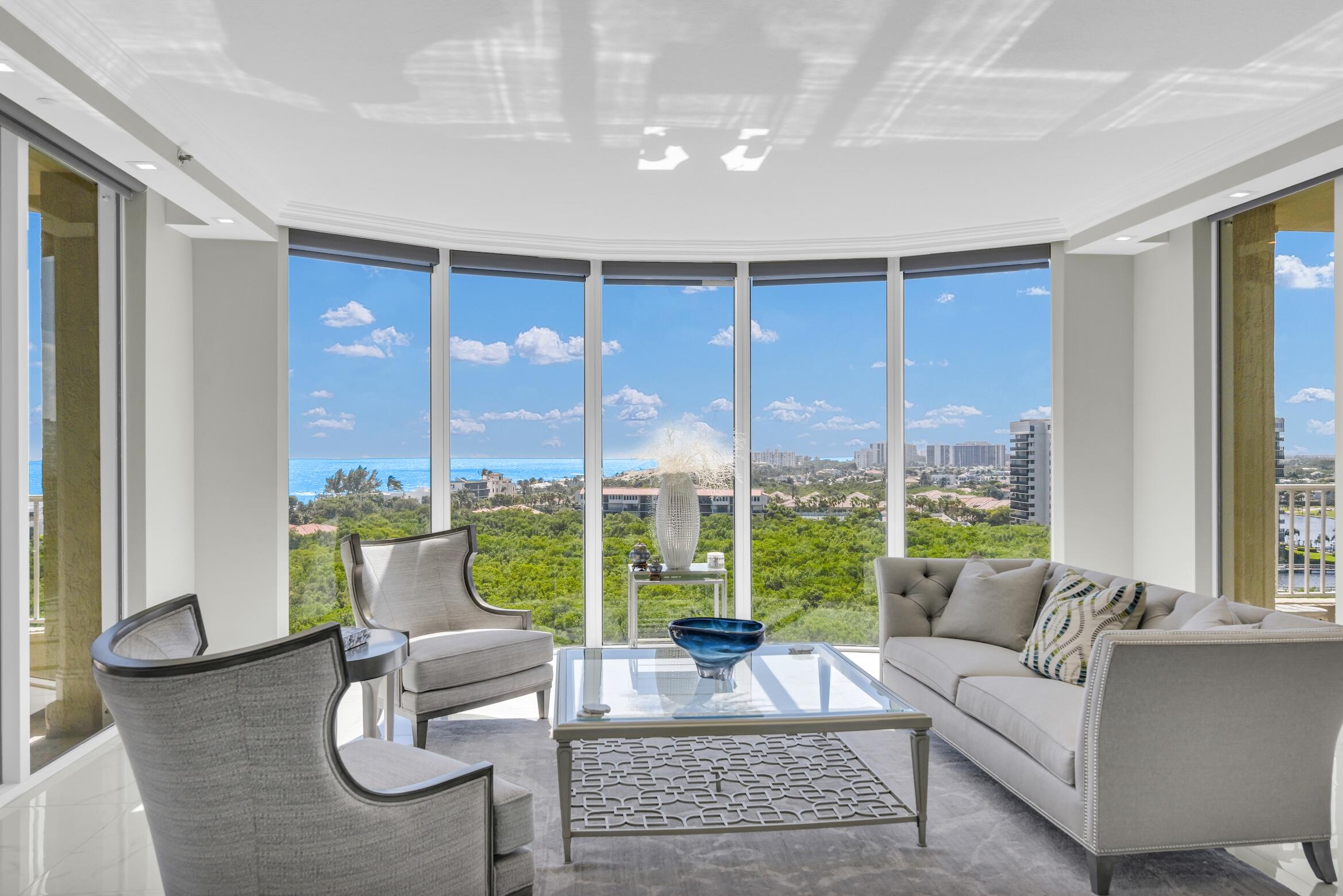 a living room with furniture and a floor to ceiling window