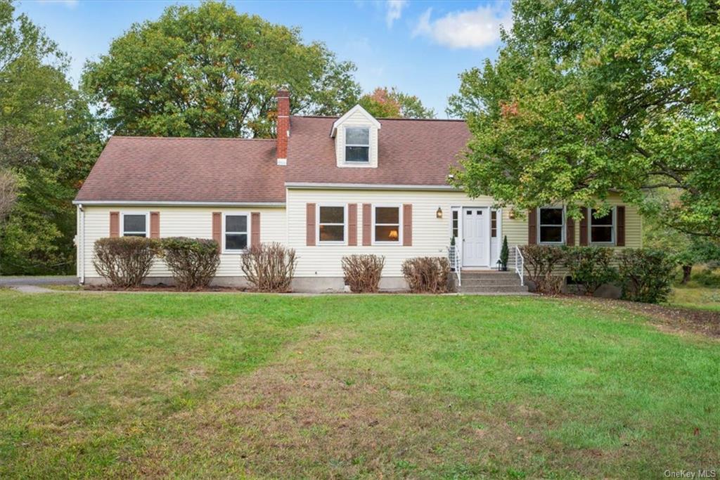 Cape cod-style house with a front lawn