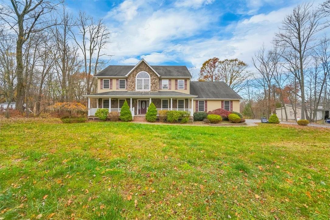 Colonial house with a porch and a front lawn