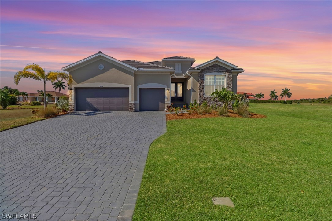 a front view of a house with a yard and garage