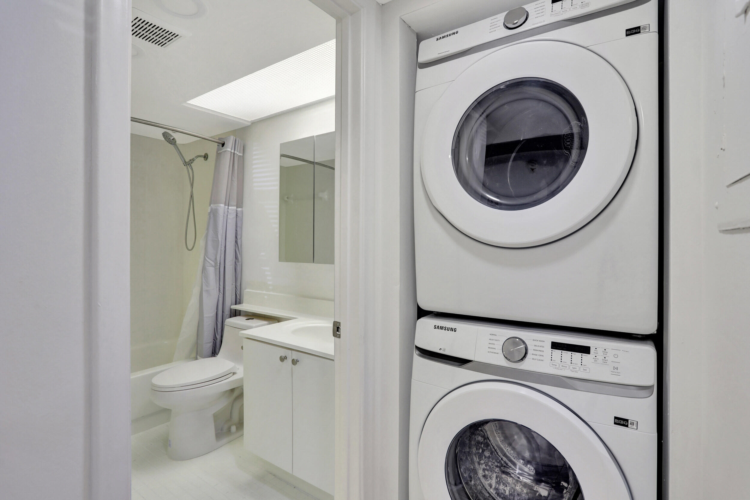 a view of a hallway with washer and dryer