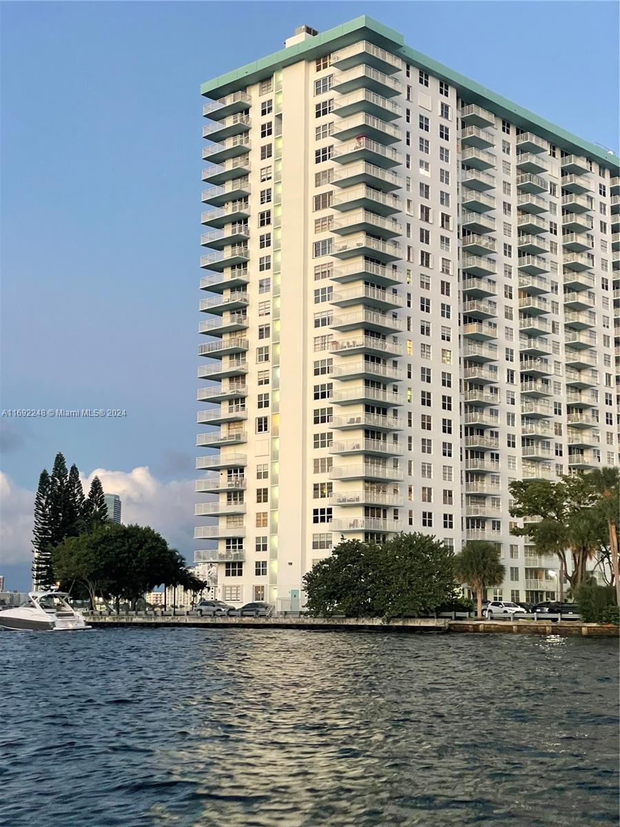 a front view of a building with a ocean view