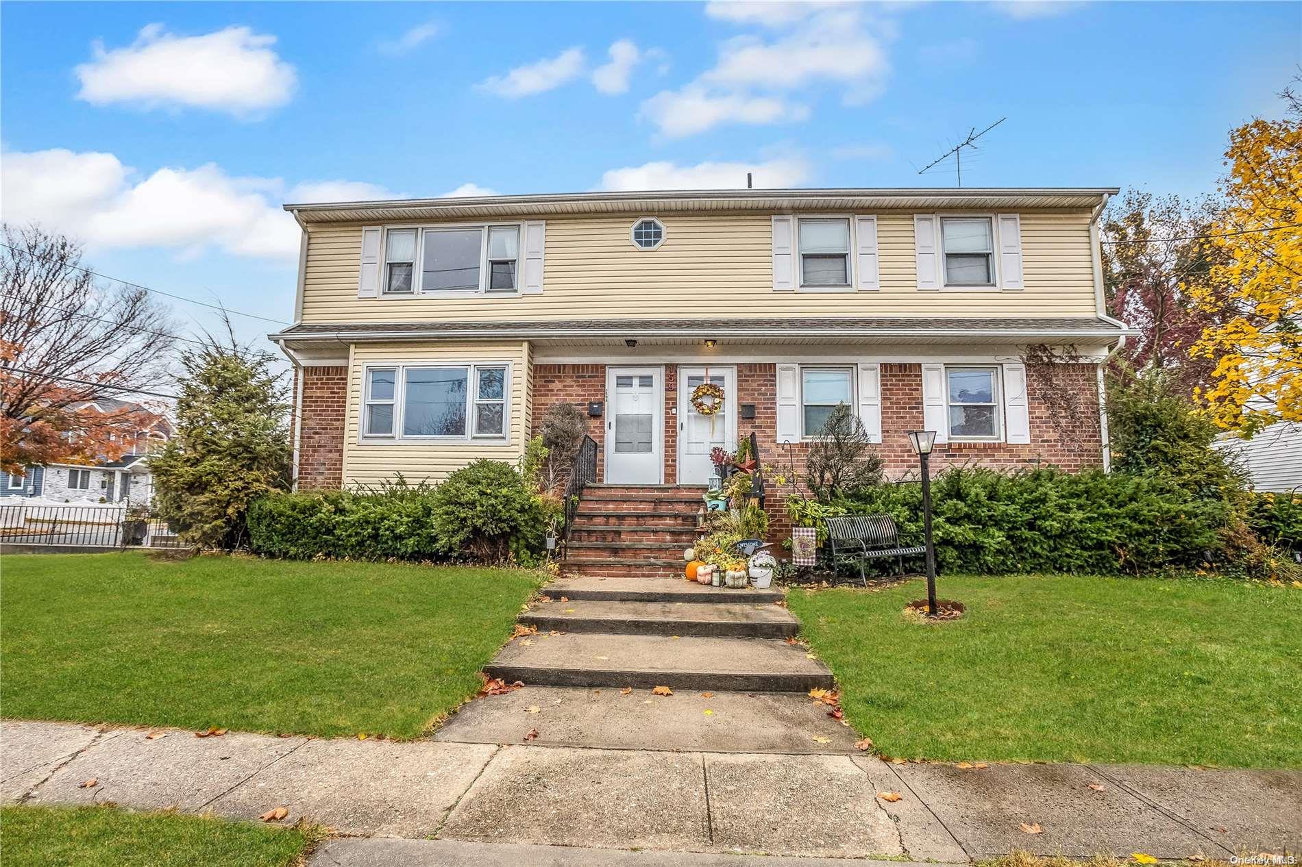 a front view of a house with a yard