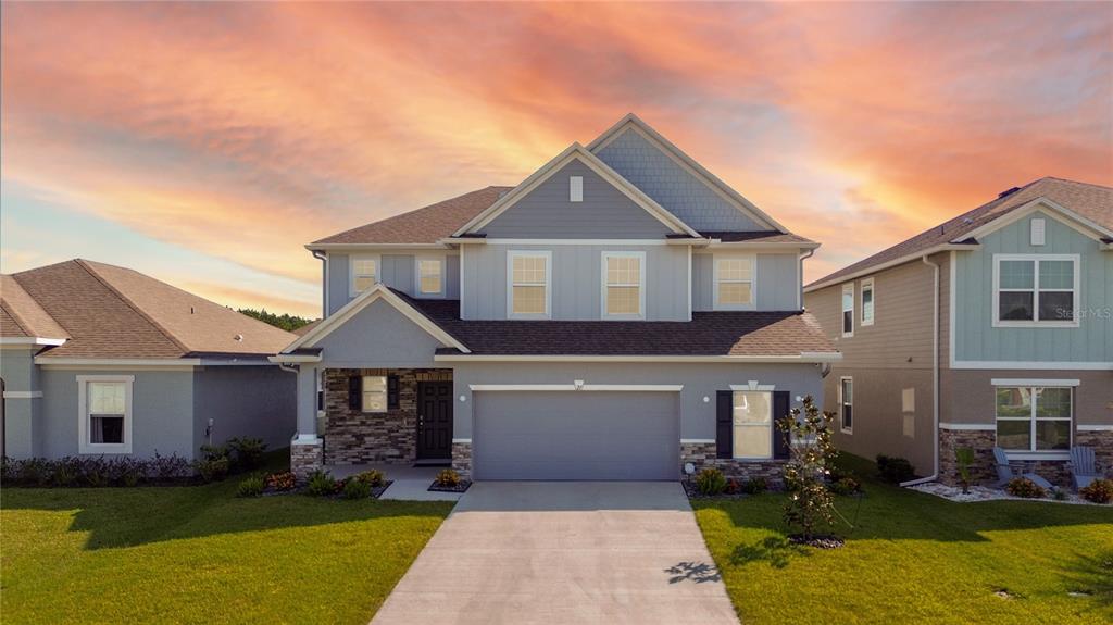 a front view of a house with a yard and garage