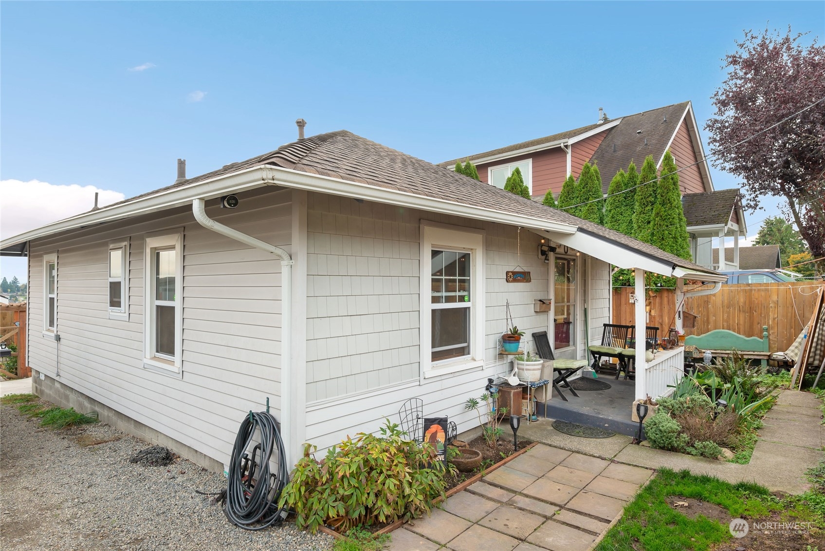 a view of a house with yard and sitting area