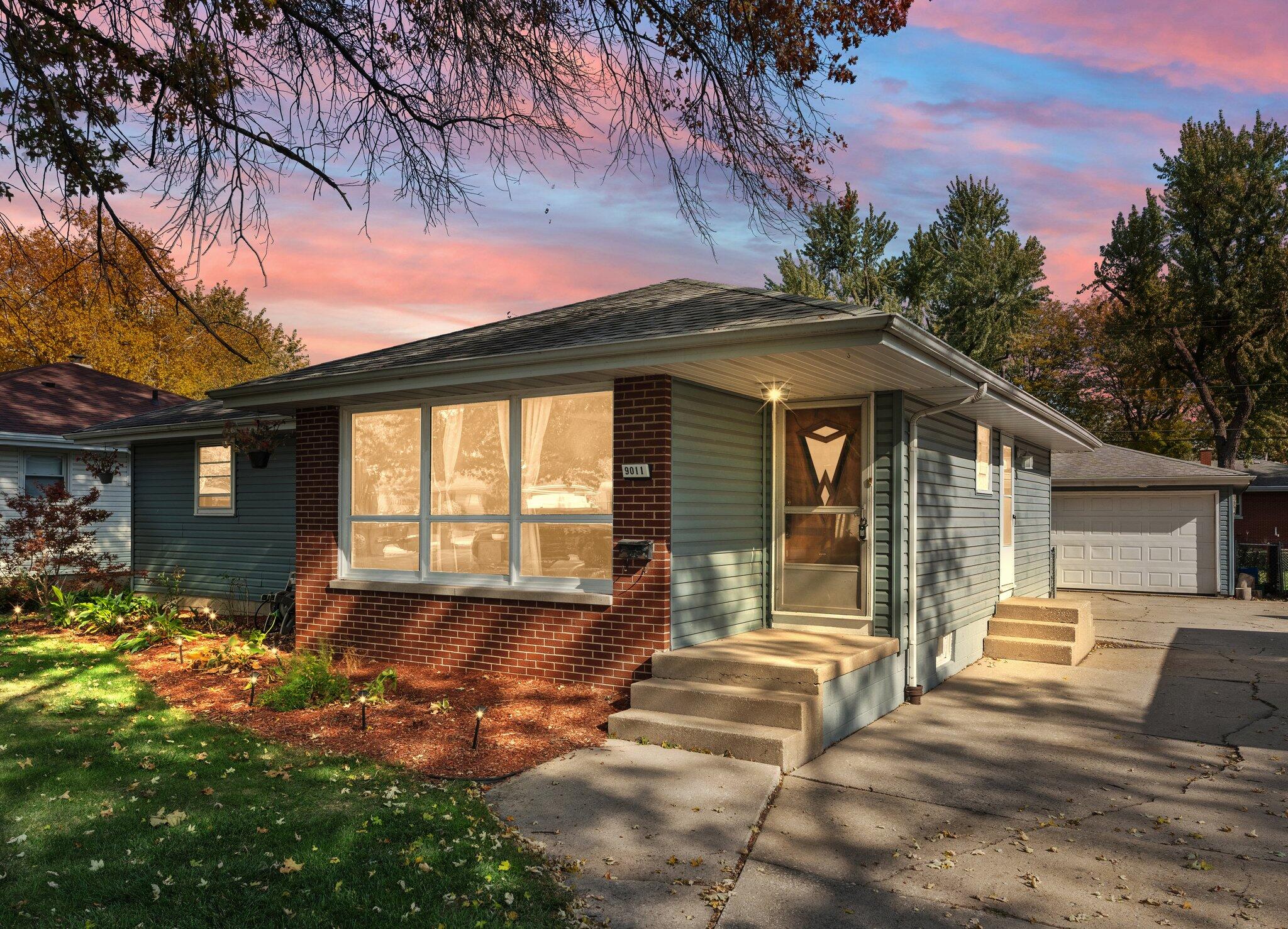 a front view of a house with a yard outdoor seating and barbeque oven