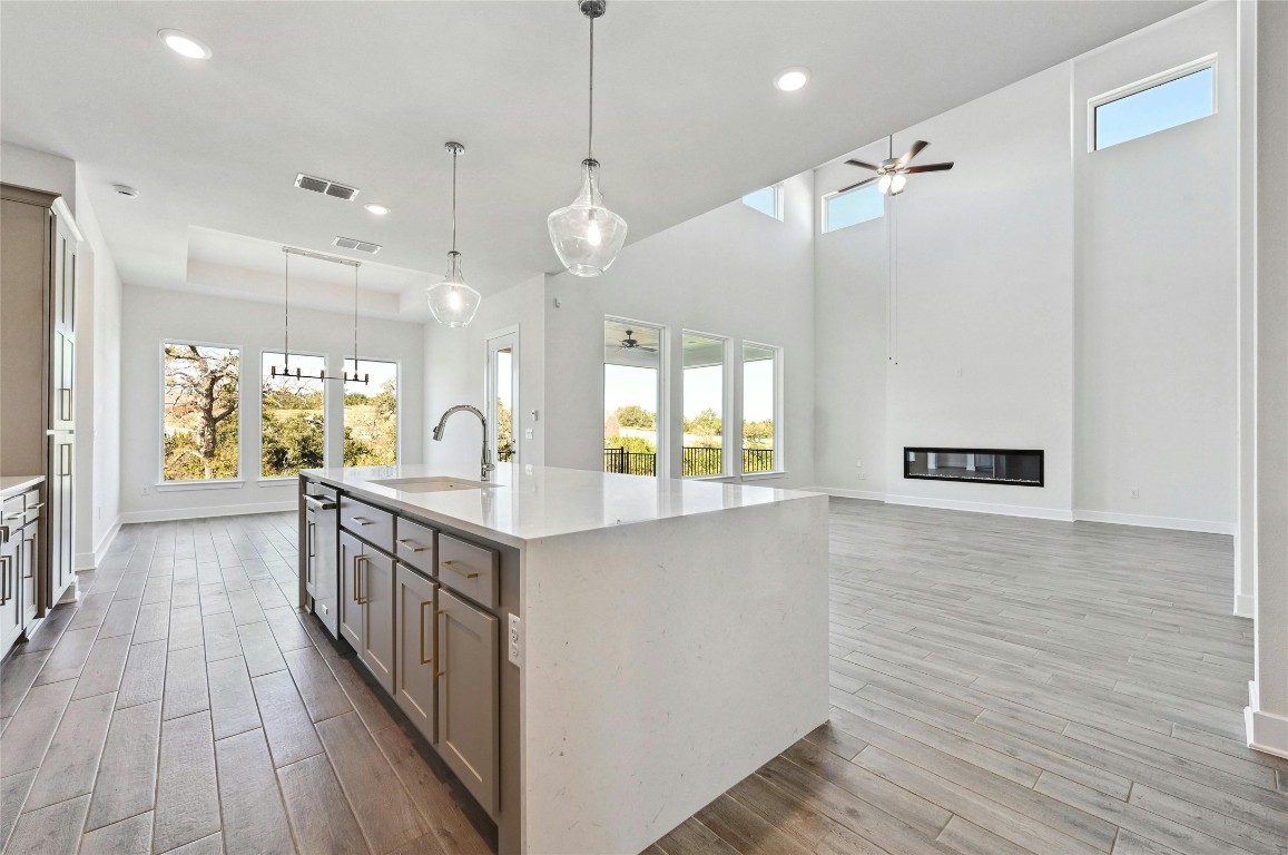 a kitchen with counter top space and wooden floor