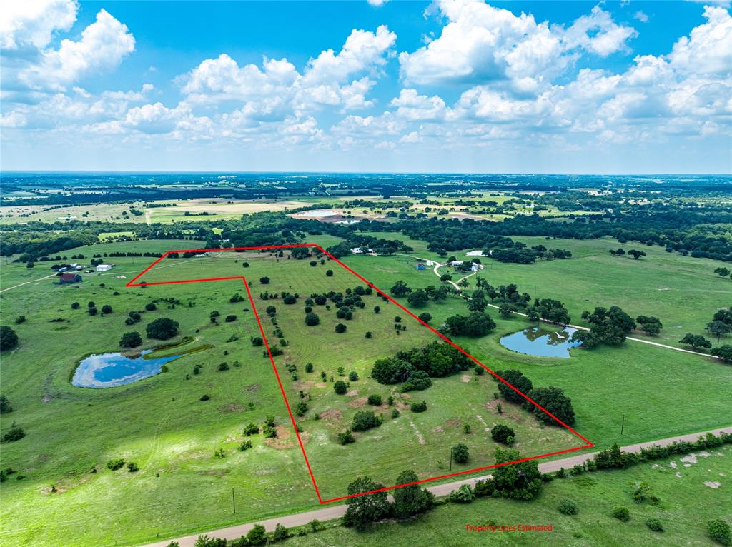 a view of a green field with lots of trees