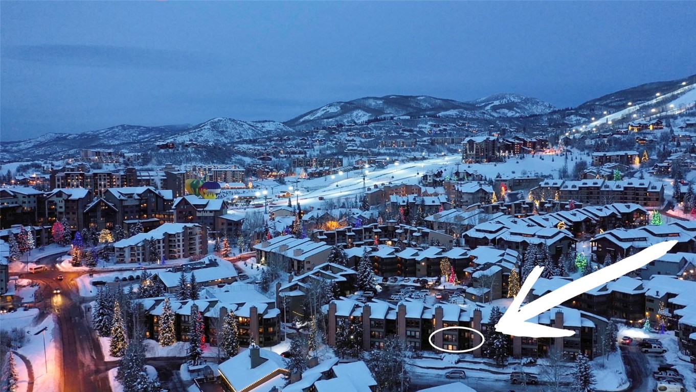 Snowy aerial view featuring a mountain view