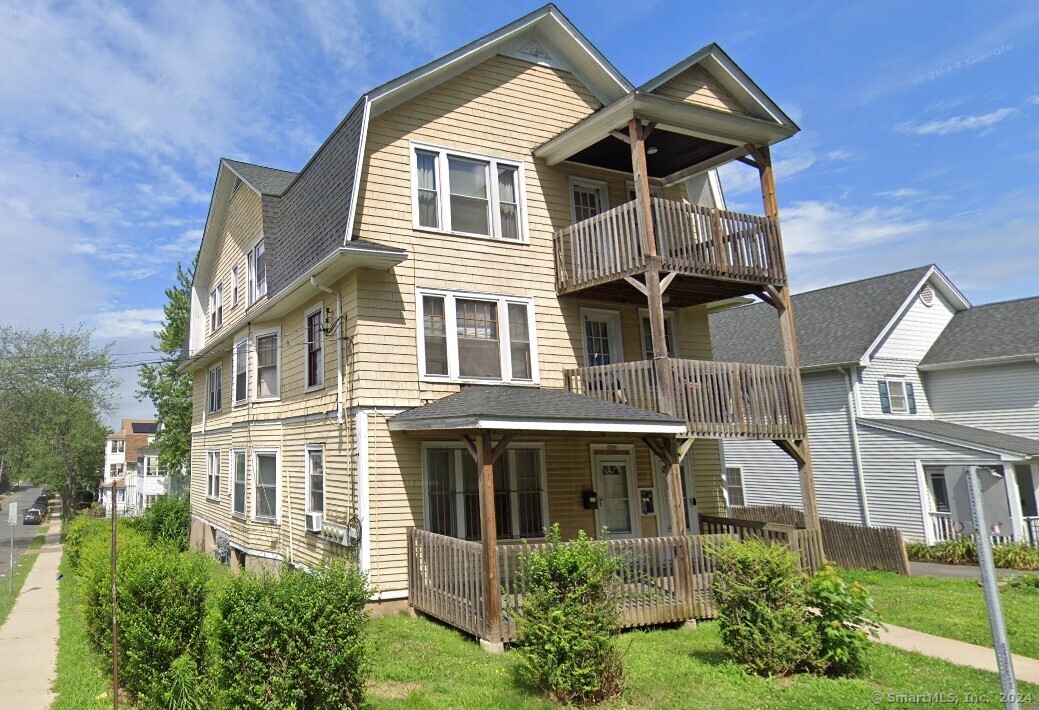 a front view of a house with a garden