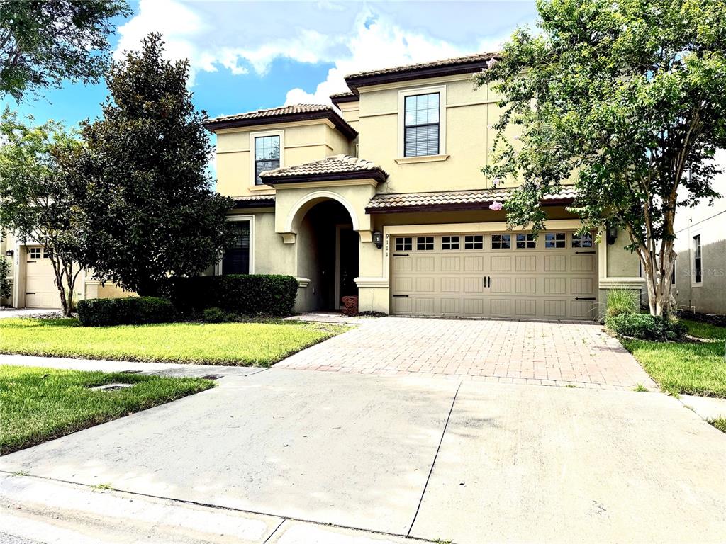 a front view of a house with a yard and garage