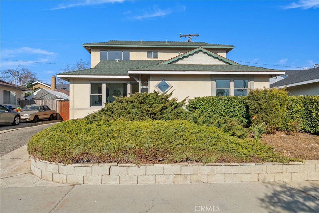 a front view of a house with a garden