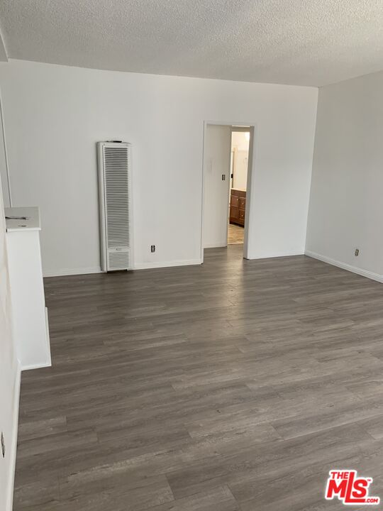 a view of an empty room and wooden floor