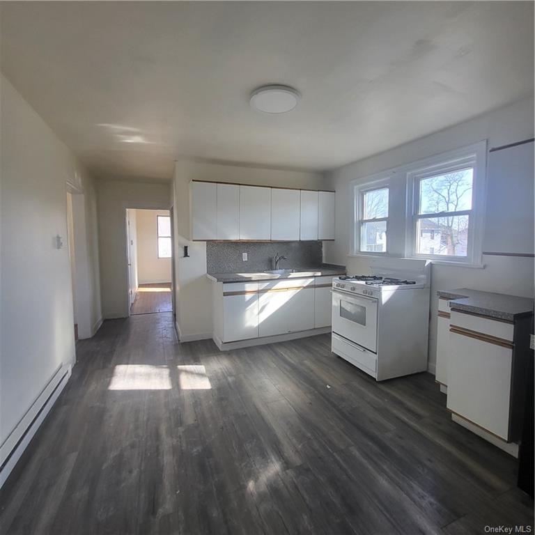 a kitchen with a white cabinets and white appliances