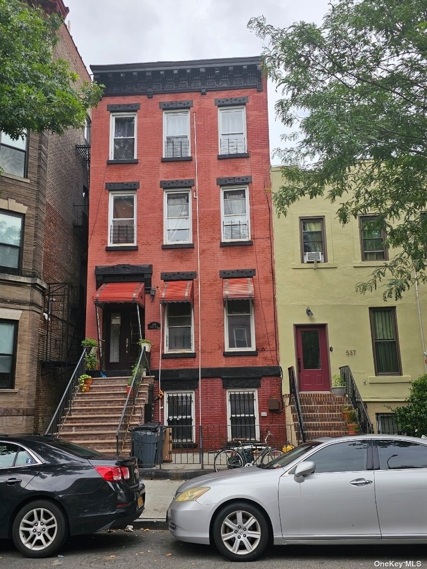 a front view of a house with parking space