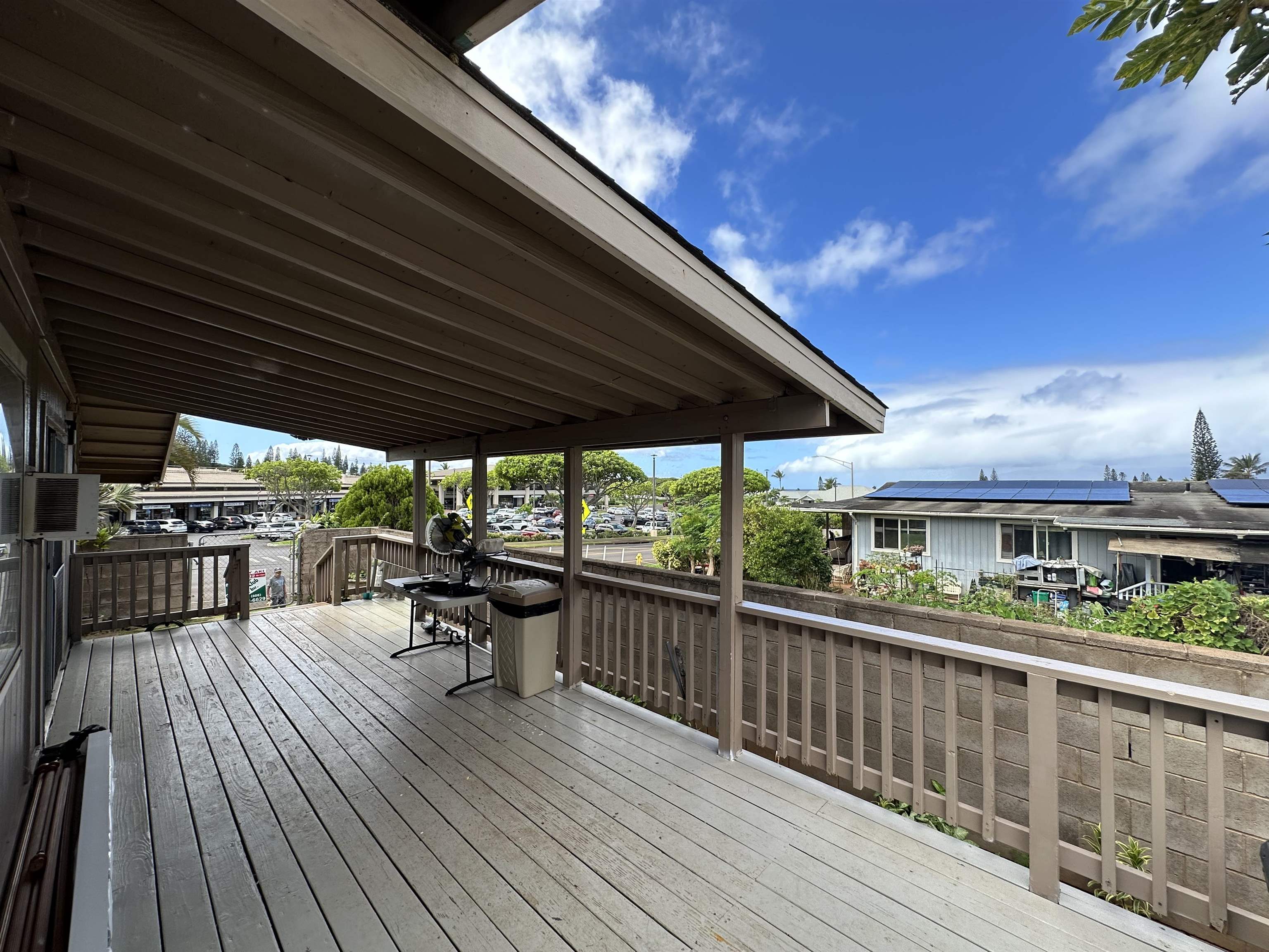 a view of a balcony with chairs and wooden floor