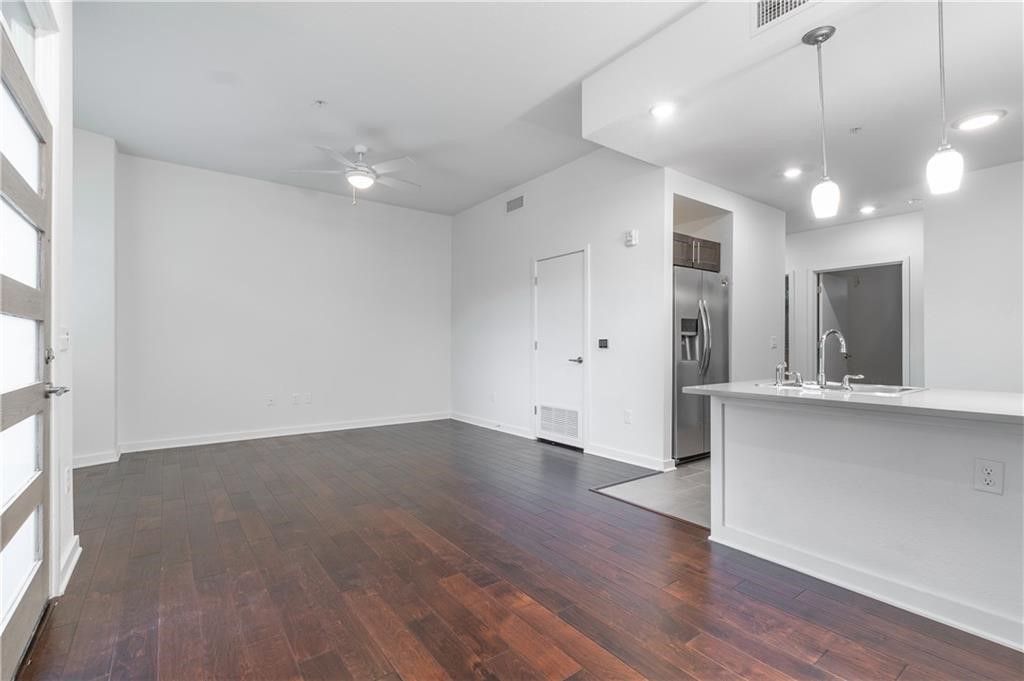 a view of a kitchen with a sink and wooden floor