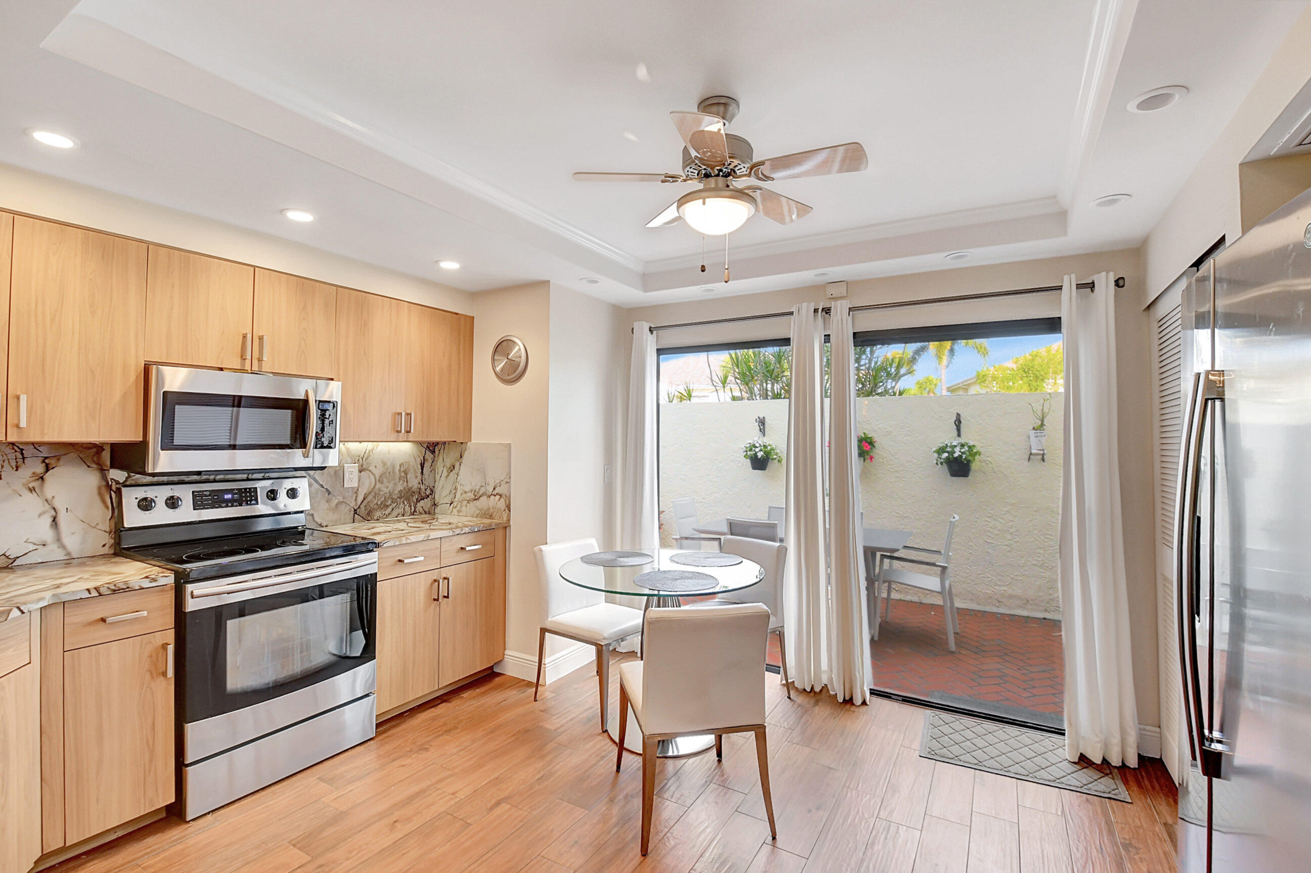 a kitchen with stainless steel appliances a stove a refrigerator and a view of living room