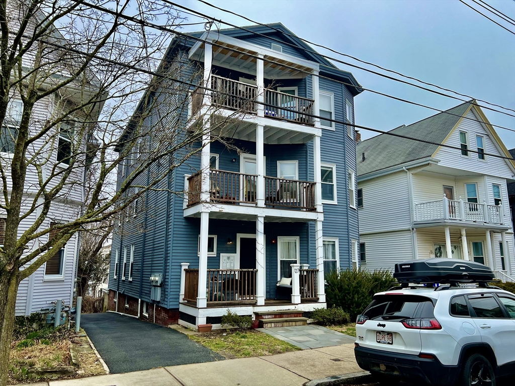 a front view of a residential apartment building with a yard