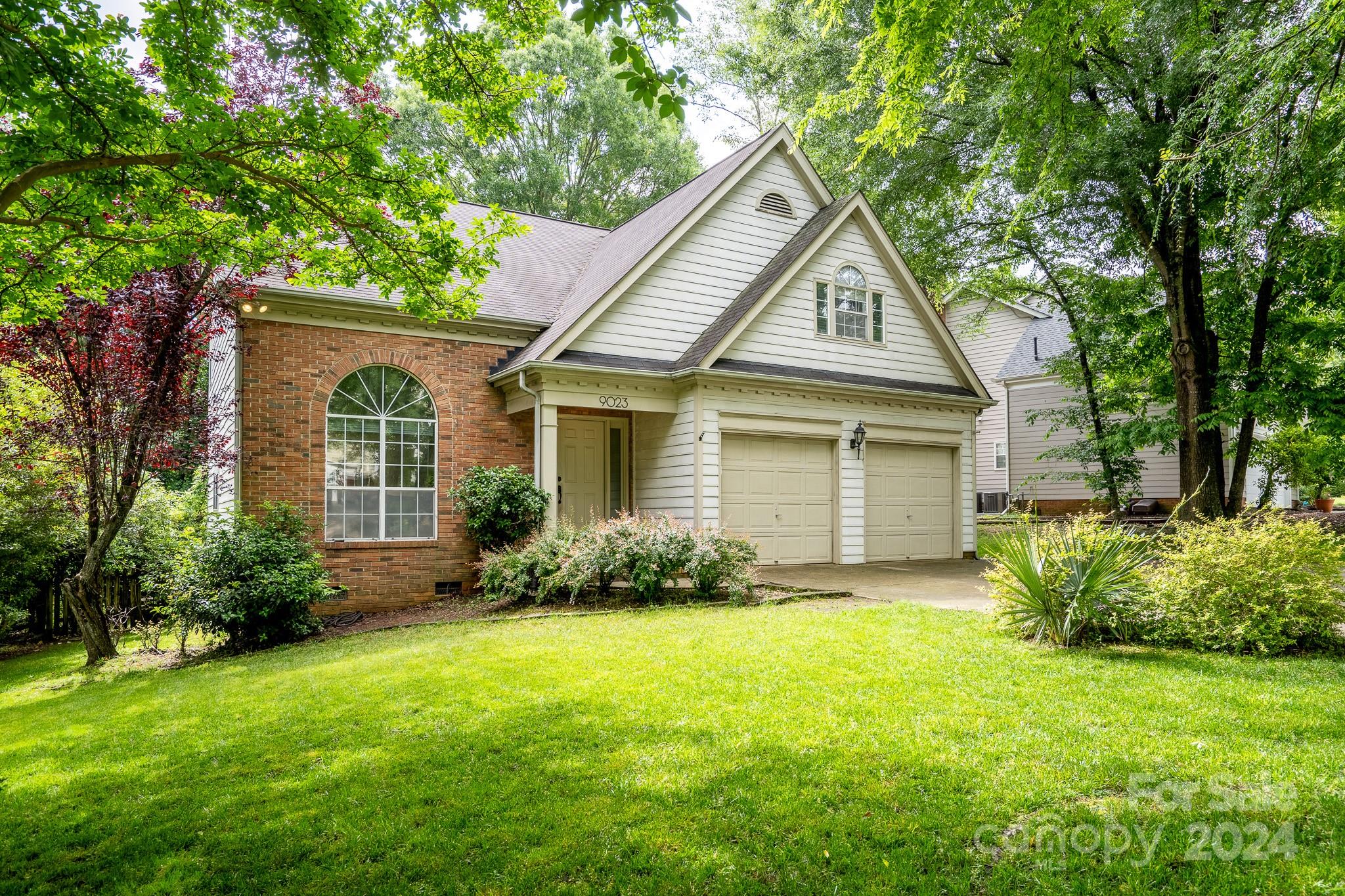 a view of a house with a yard and plants