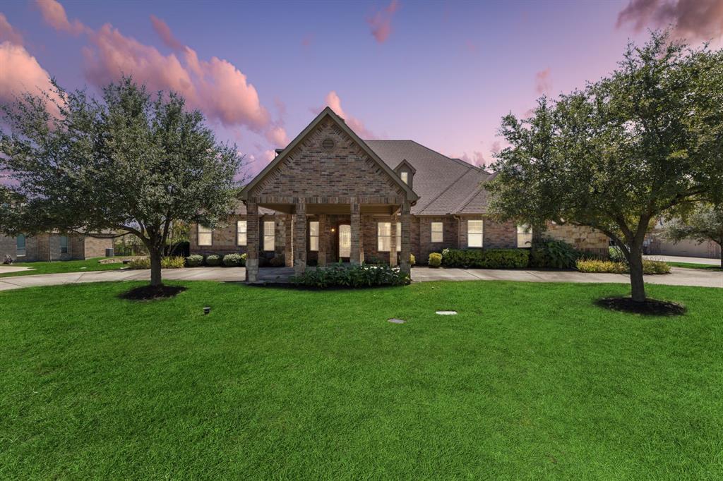 a front view of a house with a garden