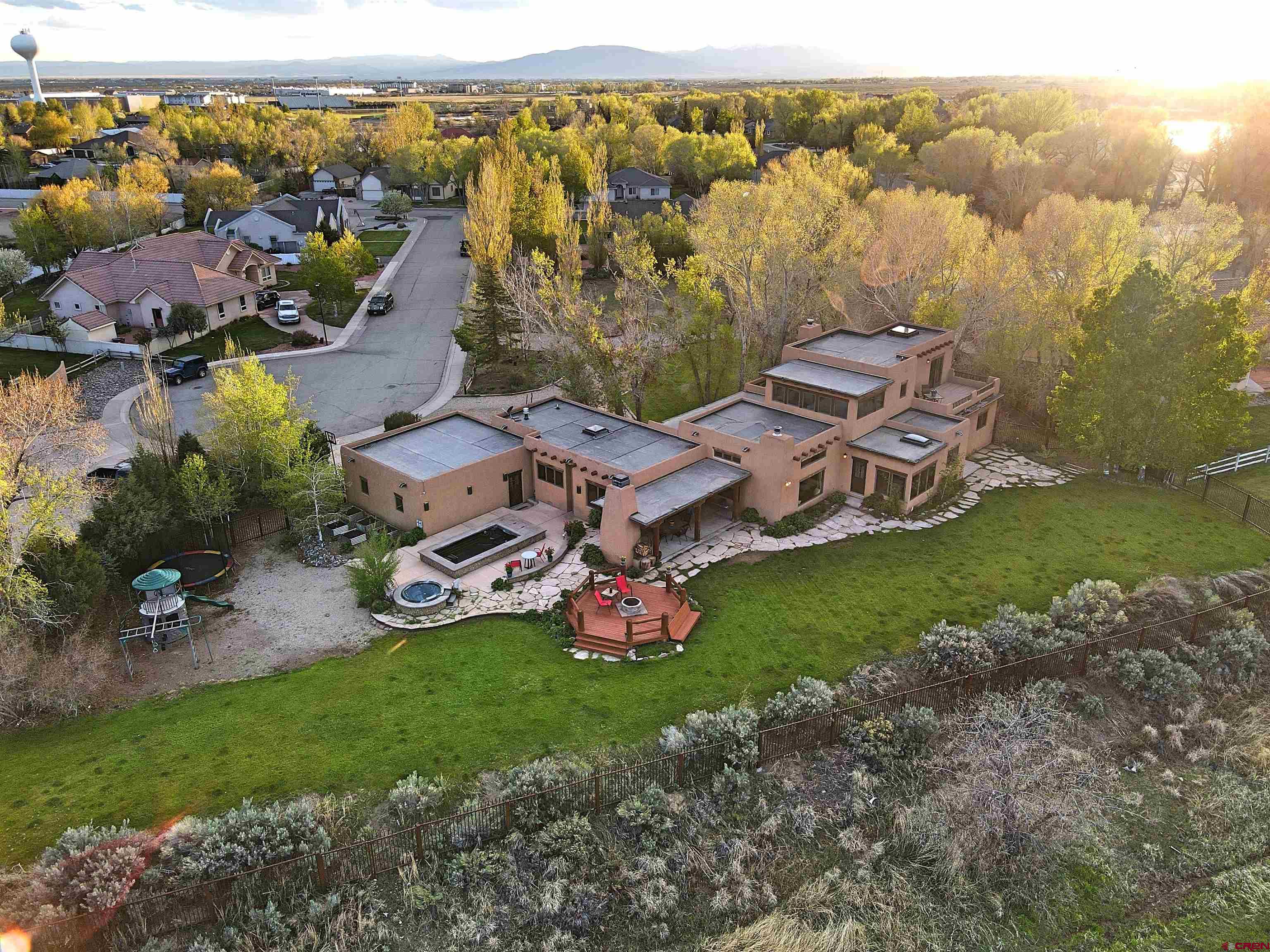 an aerial view of a house with a garden and lake view