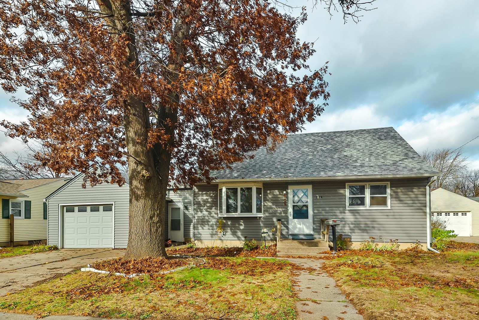 a front view of a house with yard patio and fire pit