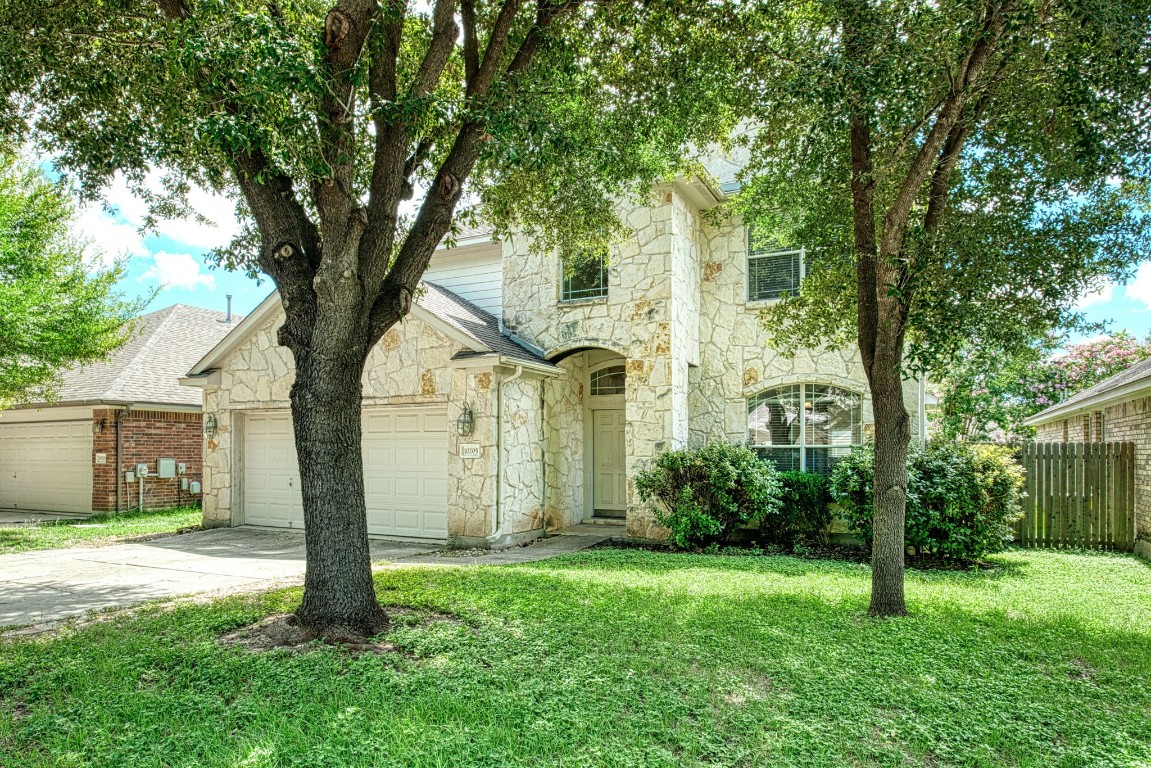 a front view of a house with garden