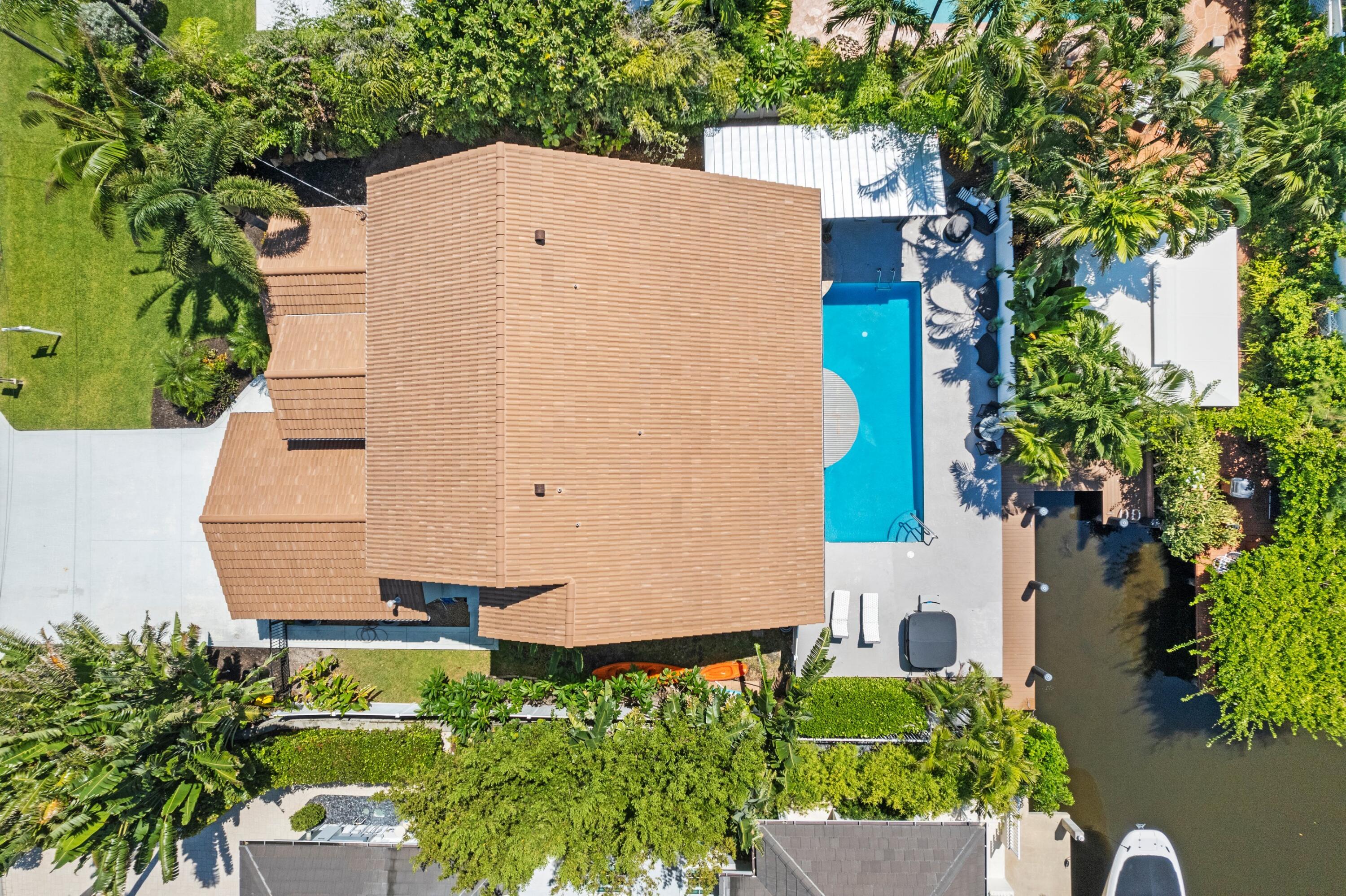 an aerial view of a house with a yard and plants