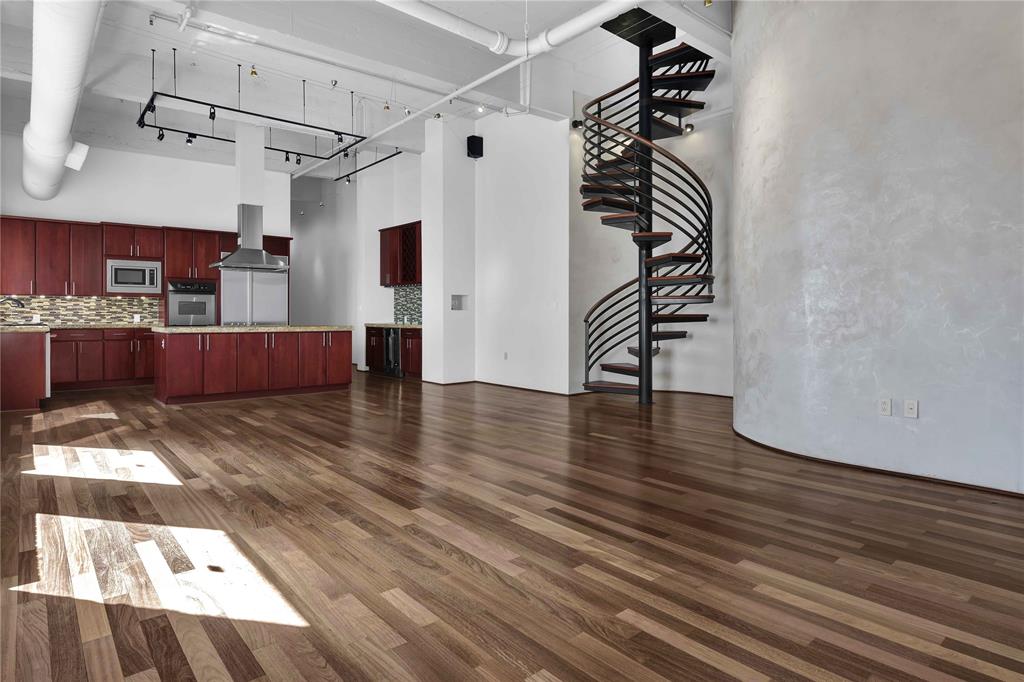 a view of a room with wooden floor