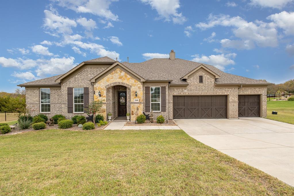 a front view of a house with a yard and garage