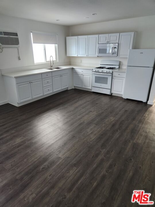 a kitchen with stainless steel appliances a refrigerator sink and cabinets