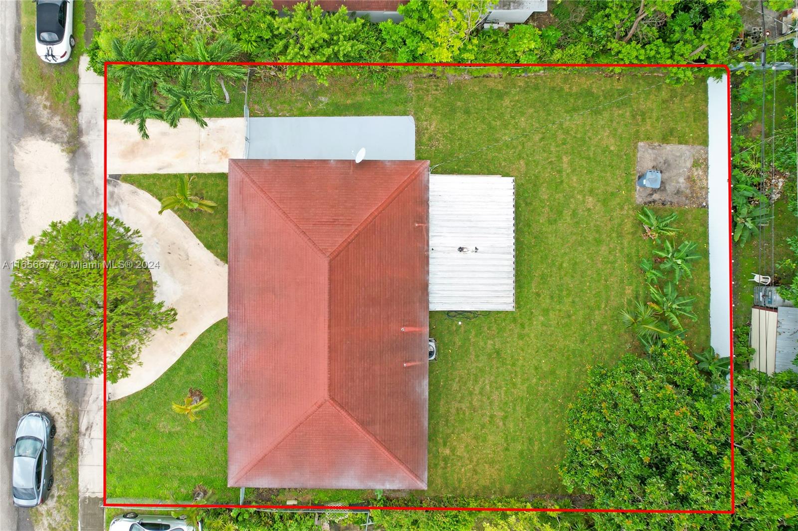 an aerial view of a house with a yard and lake view