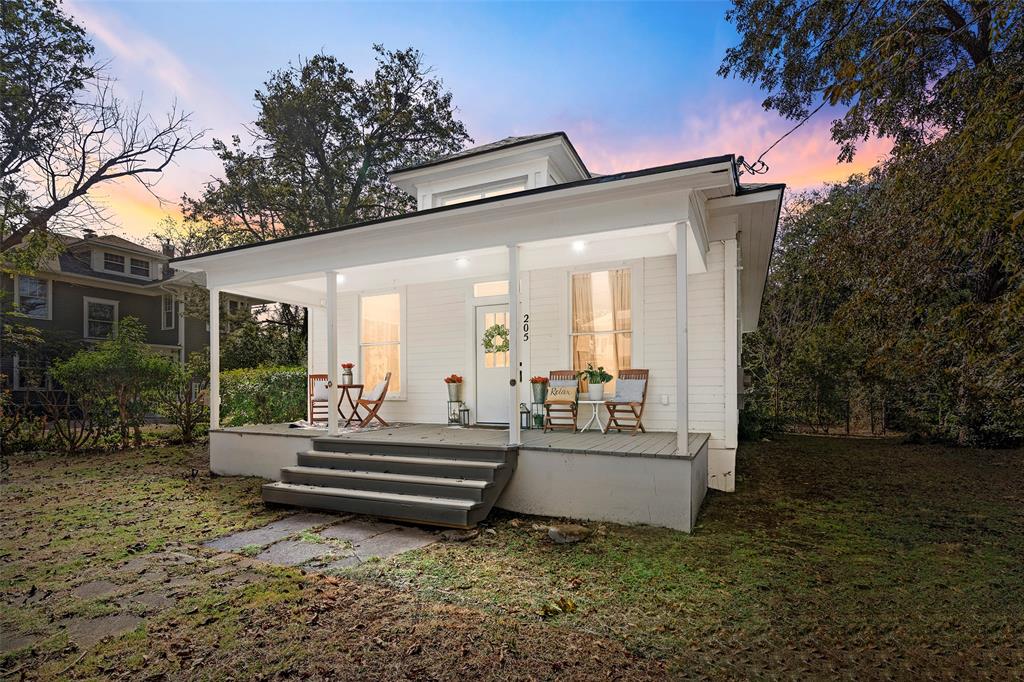 a view of a house with backyard and sitting area