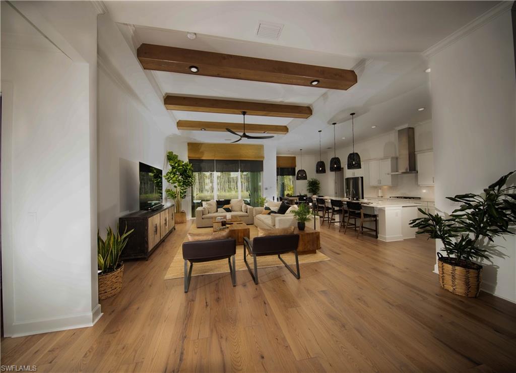 Living room/ Great room featuring beamed ceiling and light hardwood / wood-style floors