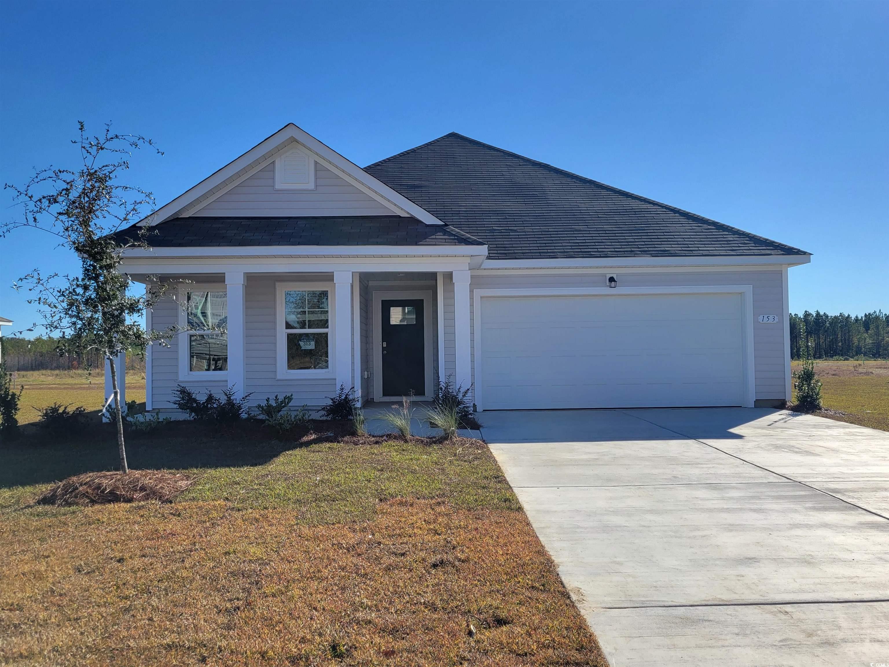 View of front of property featuring a garage and a