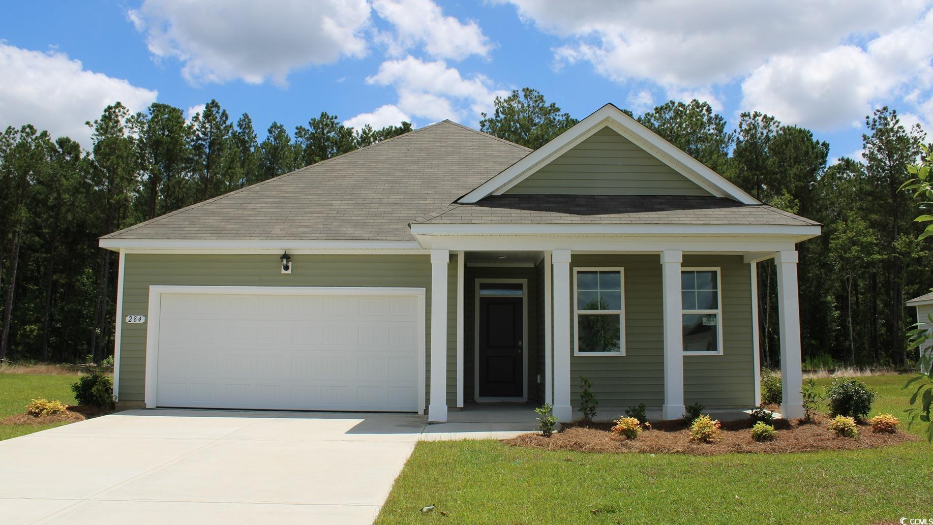 View of front facade featuring a garage and a fron