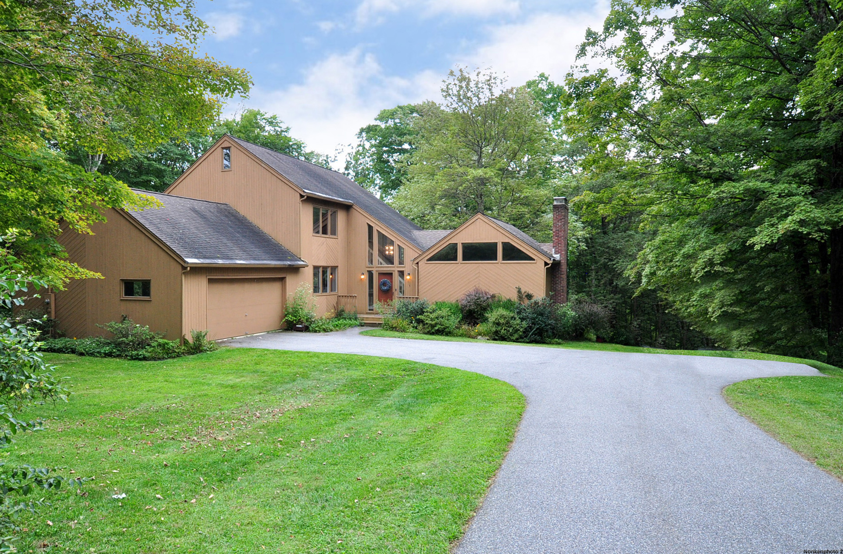 a front view of house with yard and green space