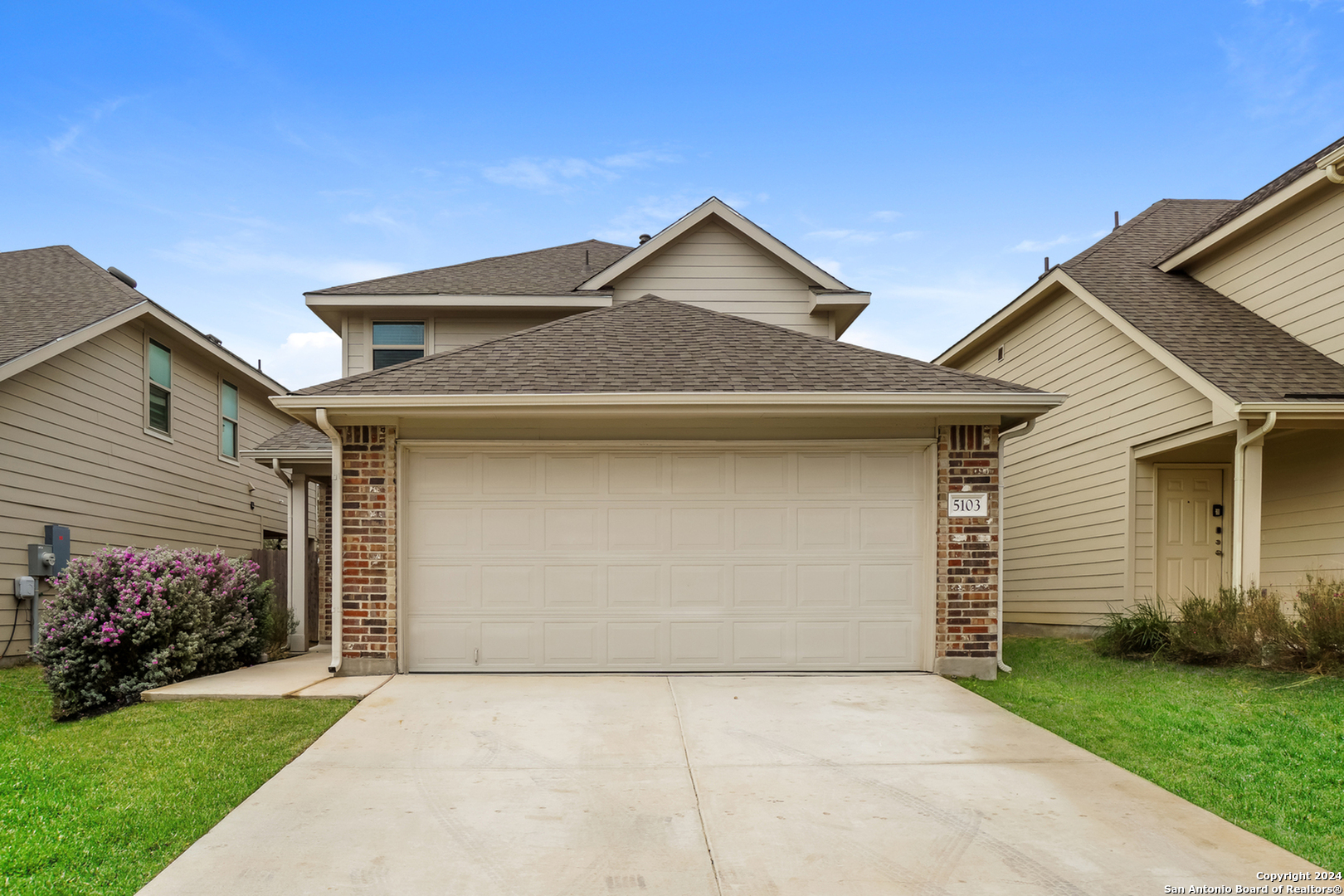 a front view of a house with a garage