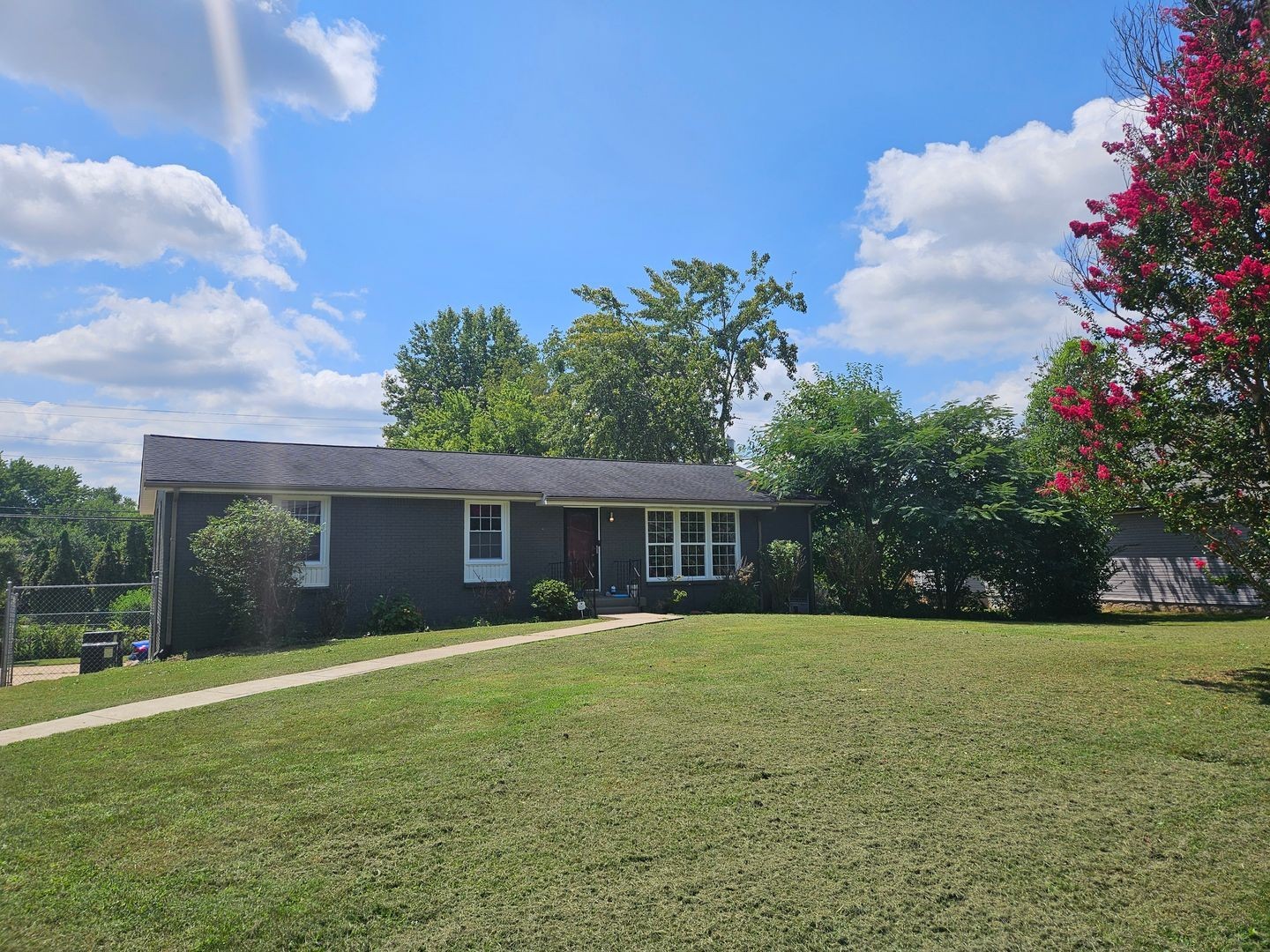 a view of house with a yard