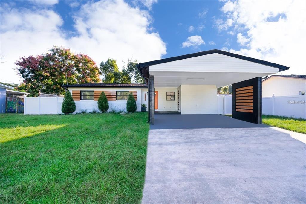 a front view of house with a garden