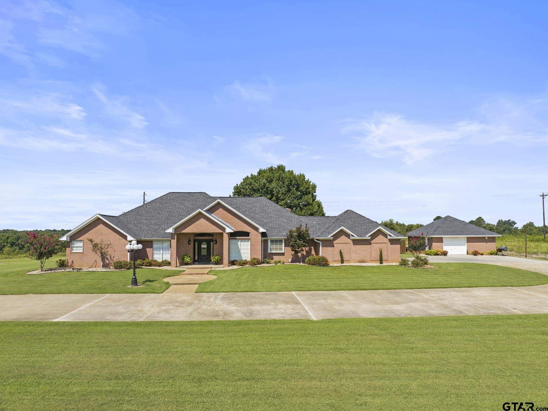 a view of house that has garden in front of it