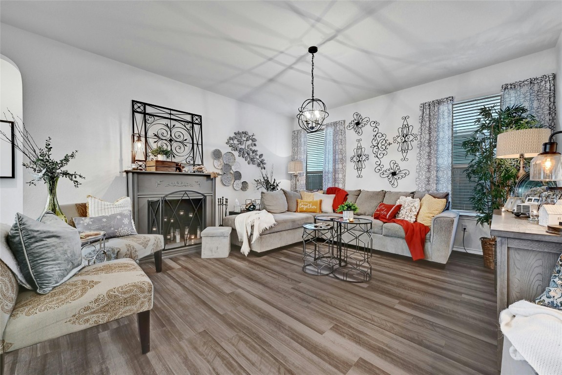 a living room with furniture and a chandelier