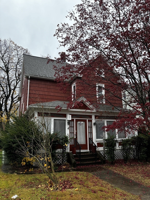 a front view of a house with a yard balcony