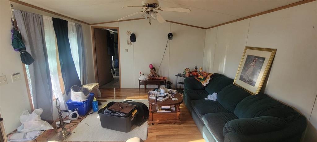 a living room with furniture a large window and a flat screen tv