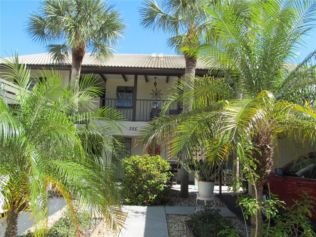 a front view of a house with a tree