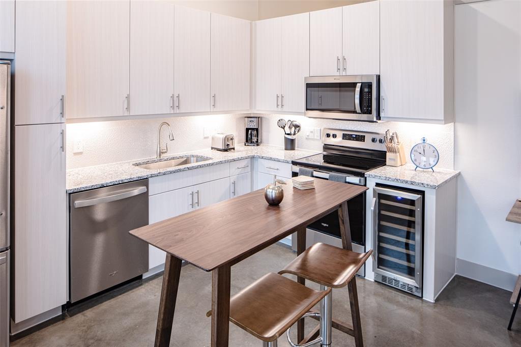 a kitchen with stainless steel appliances a stove a sink and a refrigerator