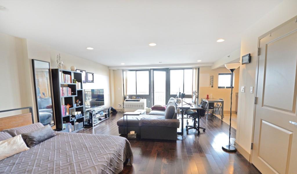 a living room with furniture window and wooden floor