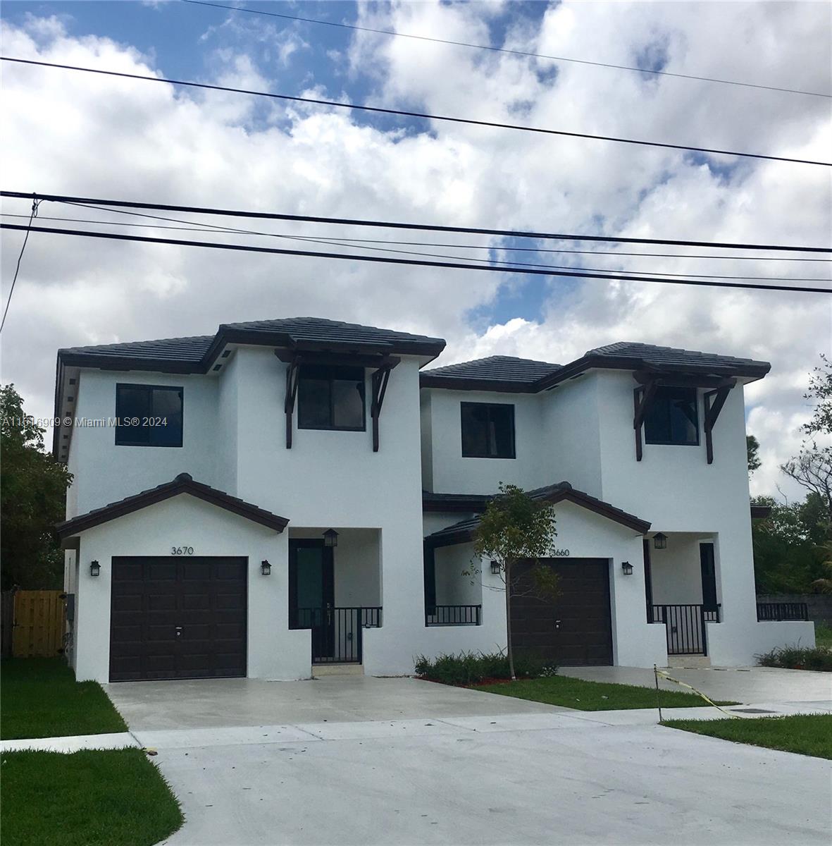 a front view of a house with garage